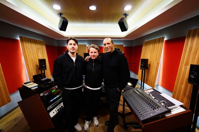 3 white males standing in an audio studio